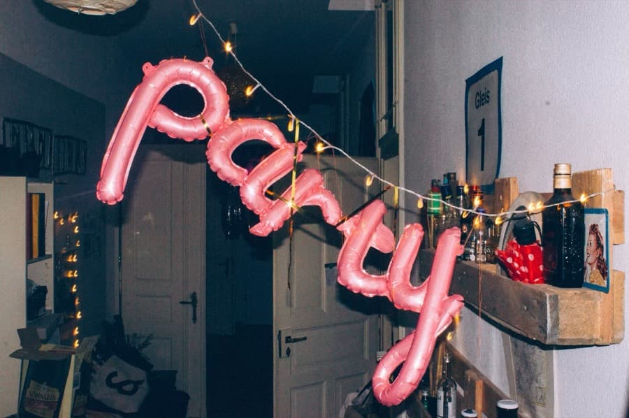 Pink foil balloons and fairy lights at a party